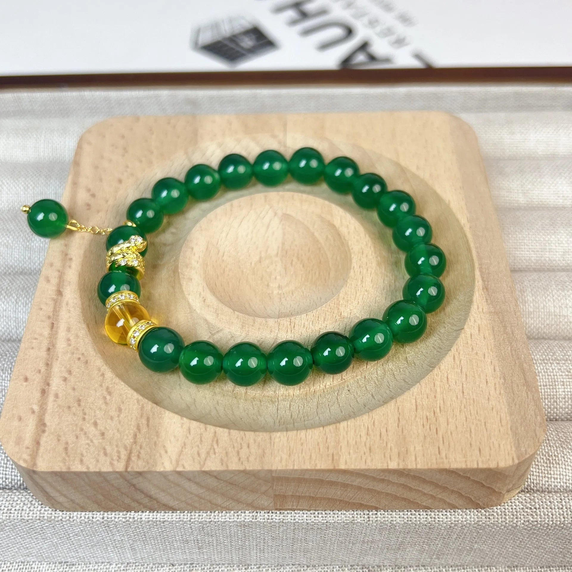 Natural green chalcedony and red agate wealth snake bracelet with copper geometric details.