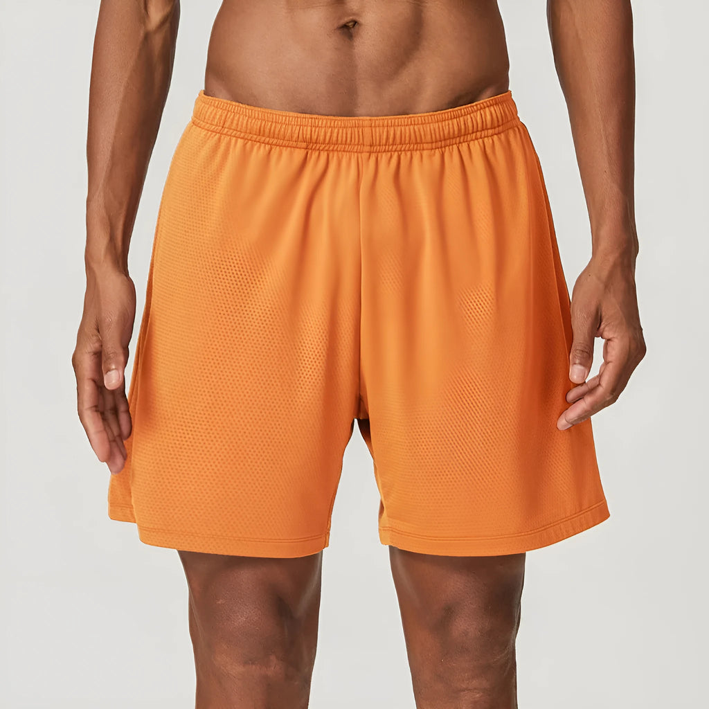 Men's quick-drying double-layer running shorts in brick red colour on a mid waist fit model.