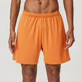 Men's quick-drying double-layer running shorts in brick red colour on a mid waist fit model.