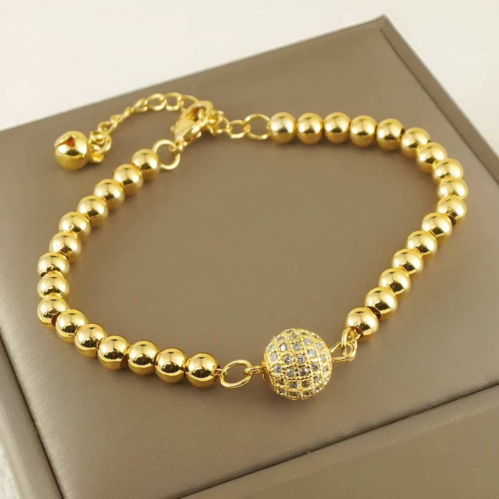 Arabic-style women's copper bracelet with a heart-shaped zircon ornament on a model's wrist.
