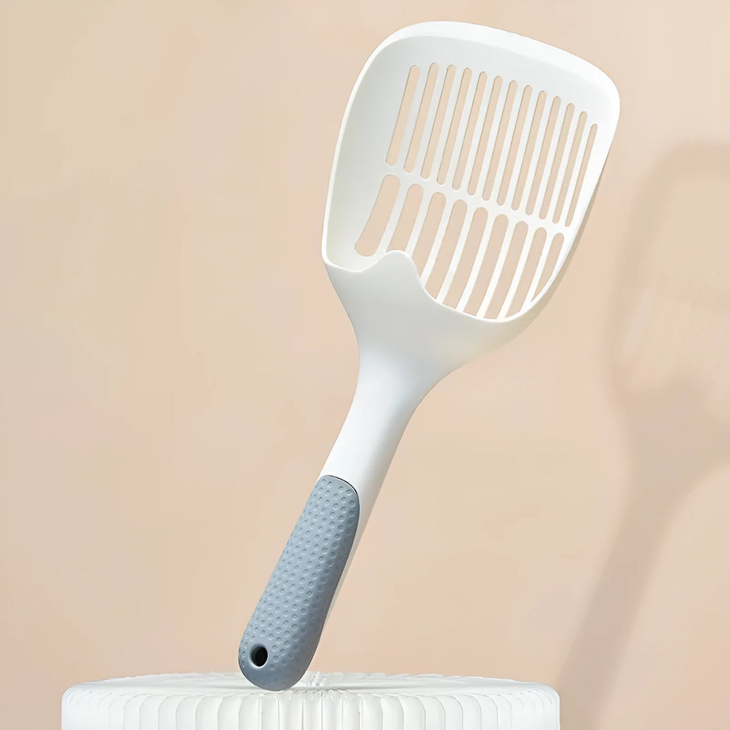 White plastic cat litter scoop with an attached storage base on a white background.