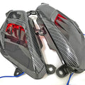 Pair of YAMAHA NMAX carbon fibre-look LED side lamp replacements on a blue background.