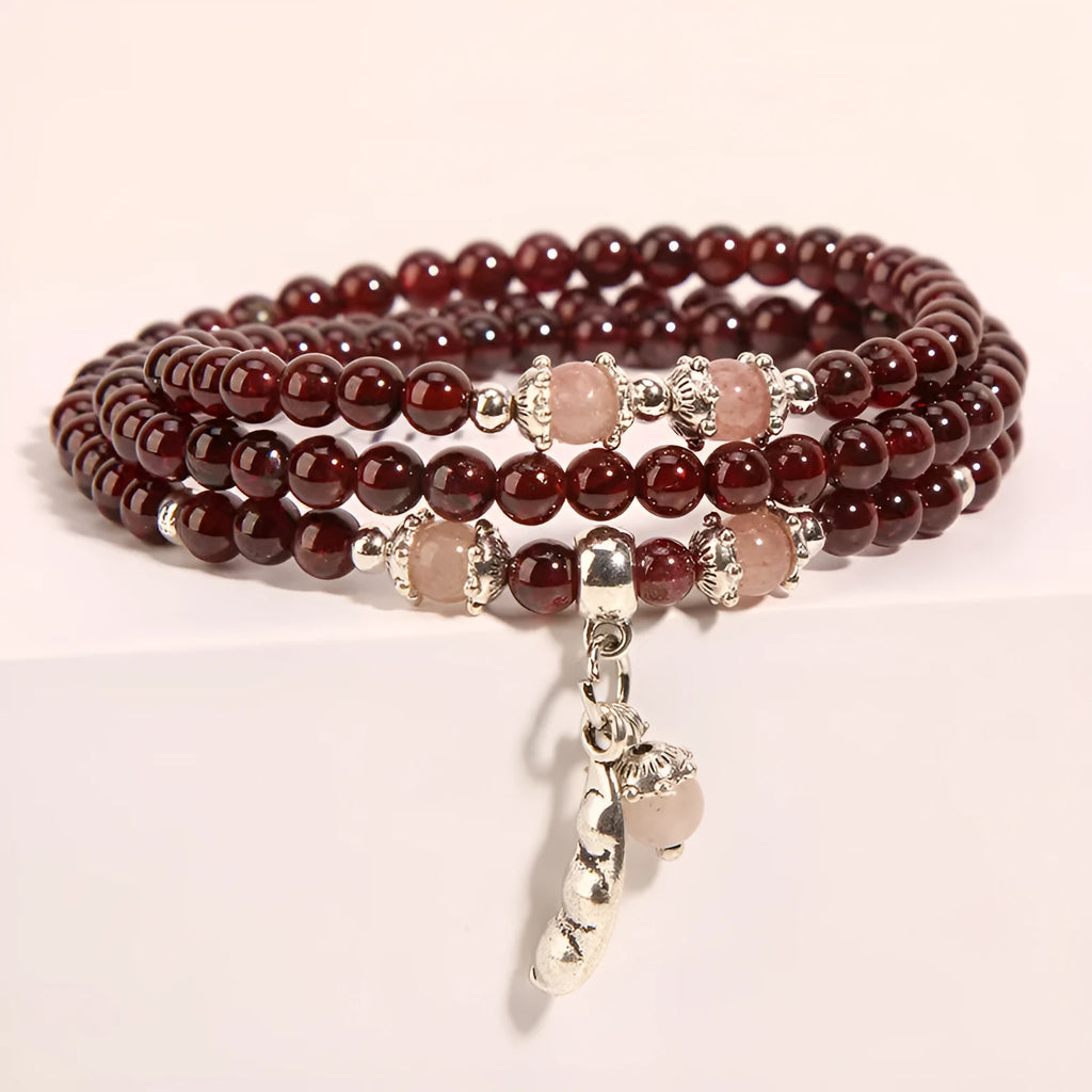 Women's Bohemian style crystal flower bracelet in wine red garnet and sauteed green beans colour.