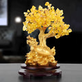 Citrine coloured small water turtle money tree resin ornament on a white background.
