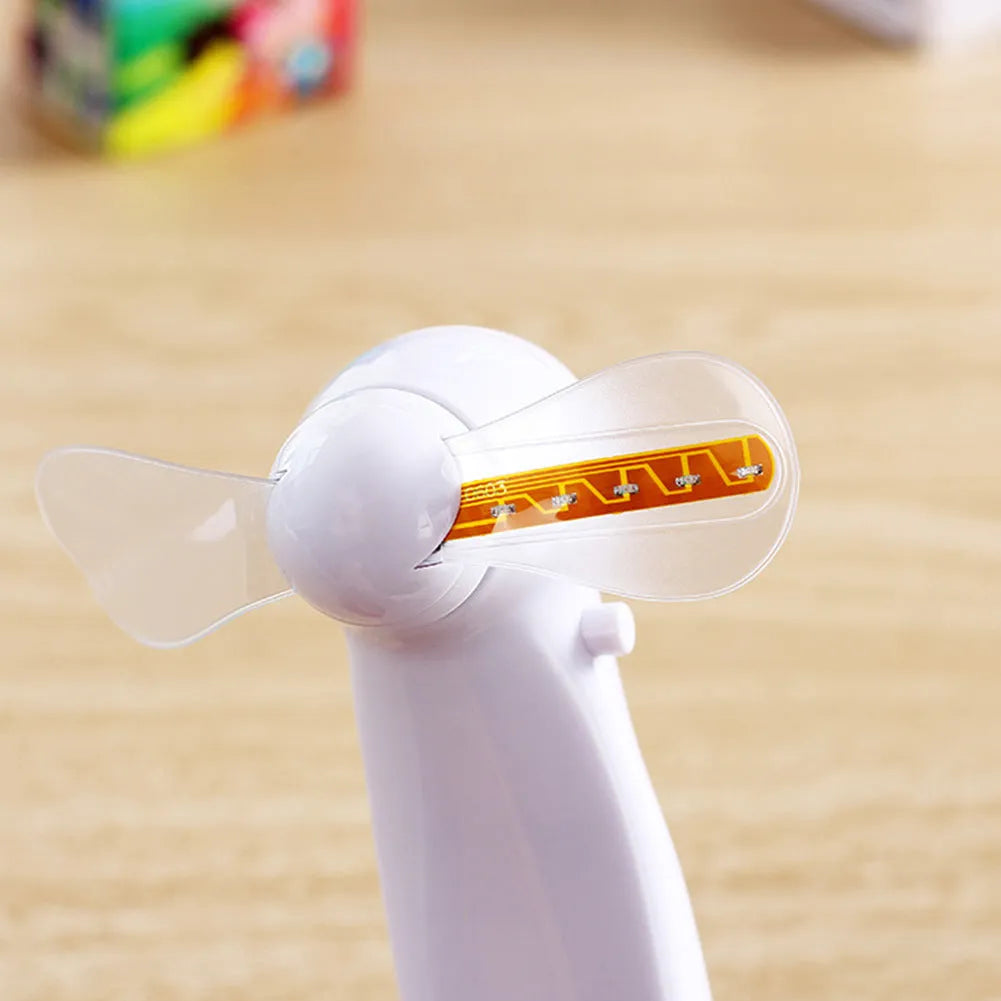 White handheld mini fan showing blue LED 'I Love You' pattern, dimensions 10.8cm.
