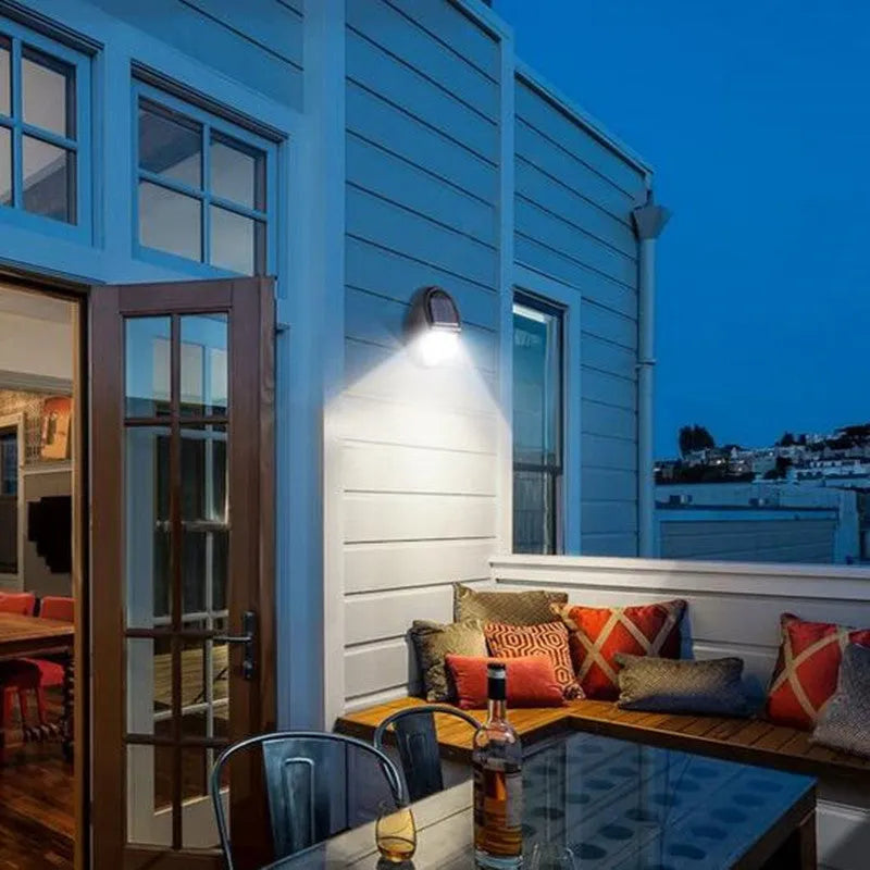 Black rectangular solar-powered LED wall light for outdoor garden use.