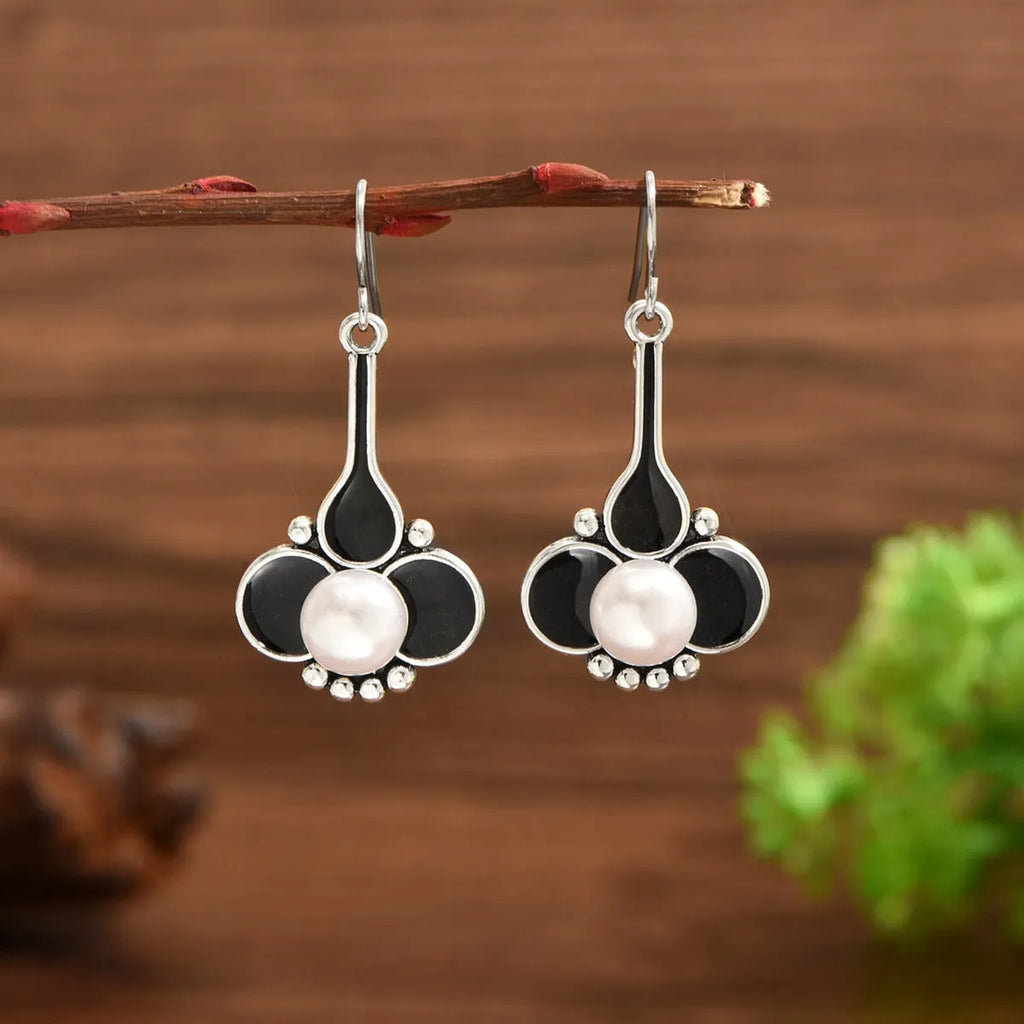 A pair of silver retro-style creative alloy earrings for women.