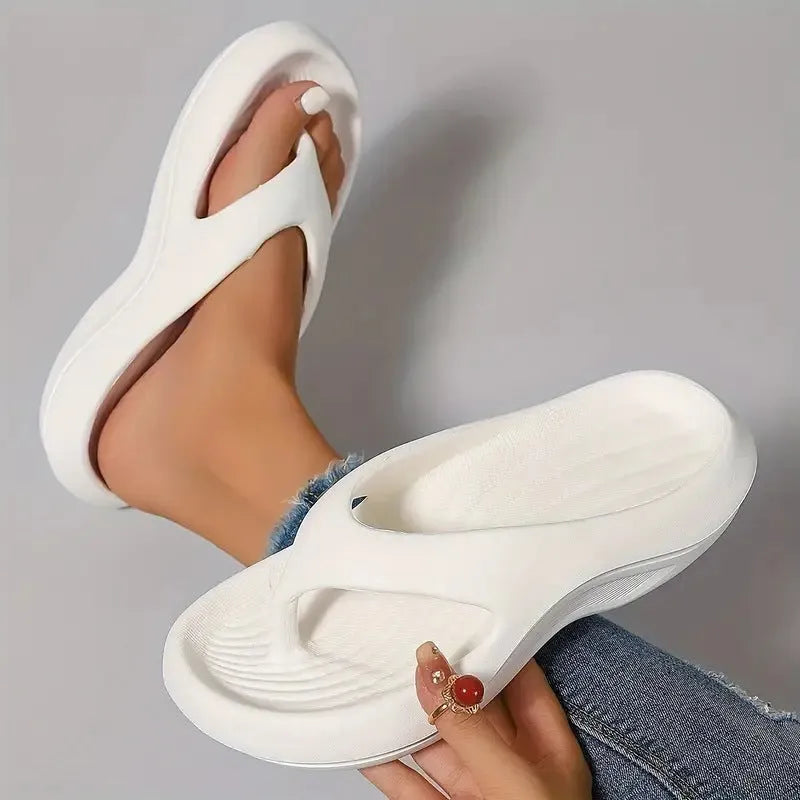 Women's black thick-soled EVA flip-flops with a non-slip sole design.