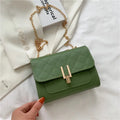 Women's white diamond lattice chain crossbody bag showing adjustable strap and structured shape