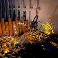 Tapered butterfly pattern iron solar garden lamp for outdoor use.