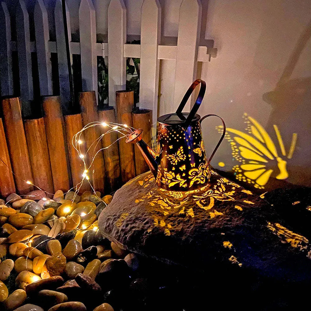 Tapered butterfly pattern iron solar garden lamp for outdoor use.