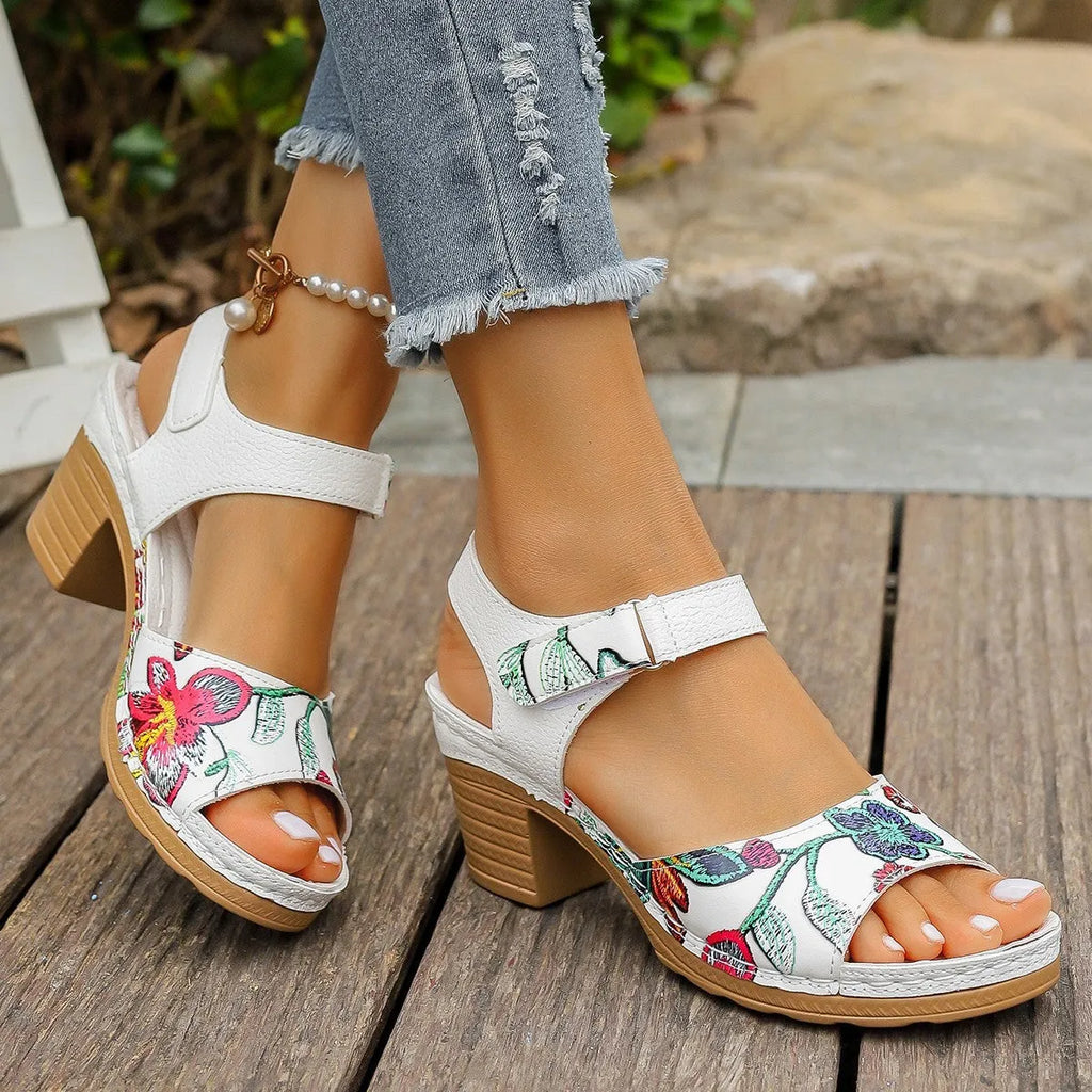 White women's high heel sandals with a Velcro strap buckle on a casual rubber sole.