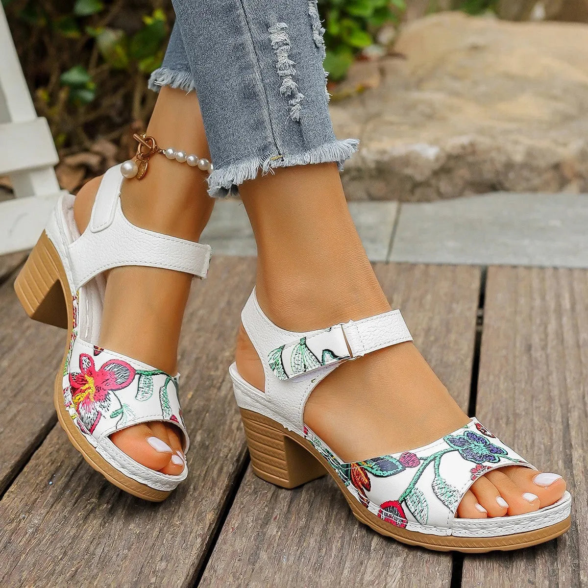 White women's high heel sandals with a Velcro strap buckle on a casual rubber sole.