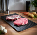 Black aluminium defrosting tray for thawing frozen meat without microwave