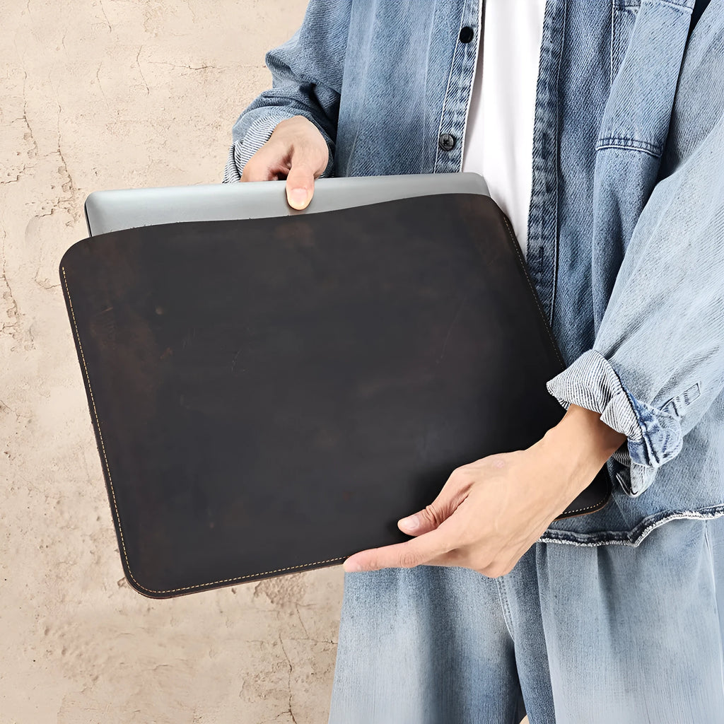 Brown genuine leather horizontal computer bag liner organiser with a laptop inside