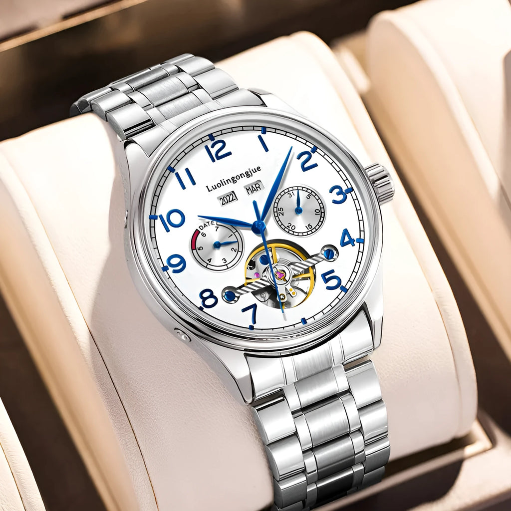 Men's silver stainless steel mechanical watch with white dial and brown leather strap.
