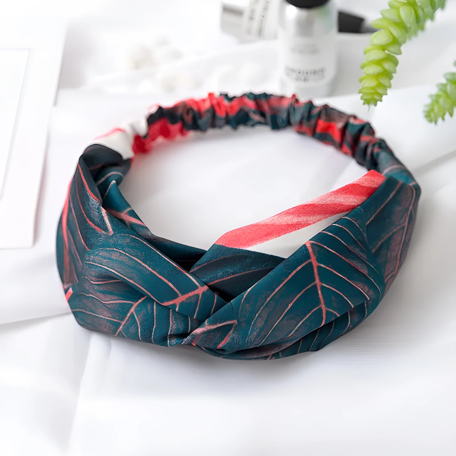 Red cloth headband with woven banana leaf design and cross hair pattern