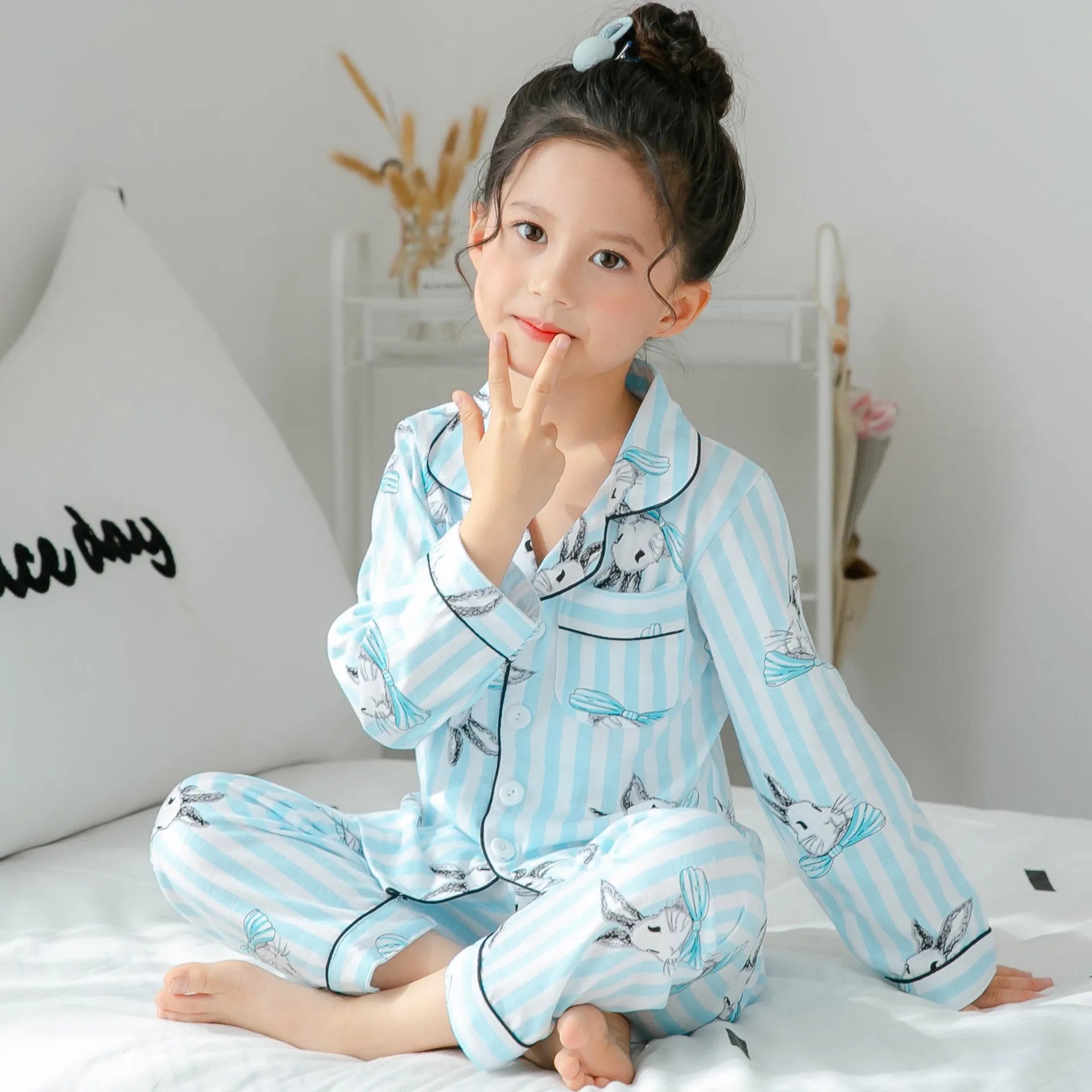 Child wearing striped cotton fleece pyjamas, showing the soft fabric and pattern detail.