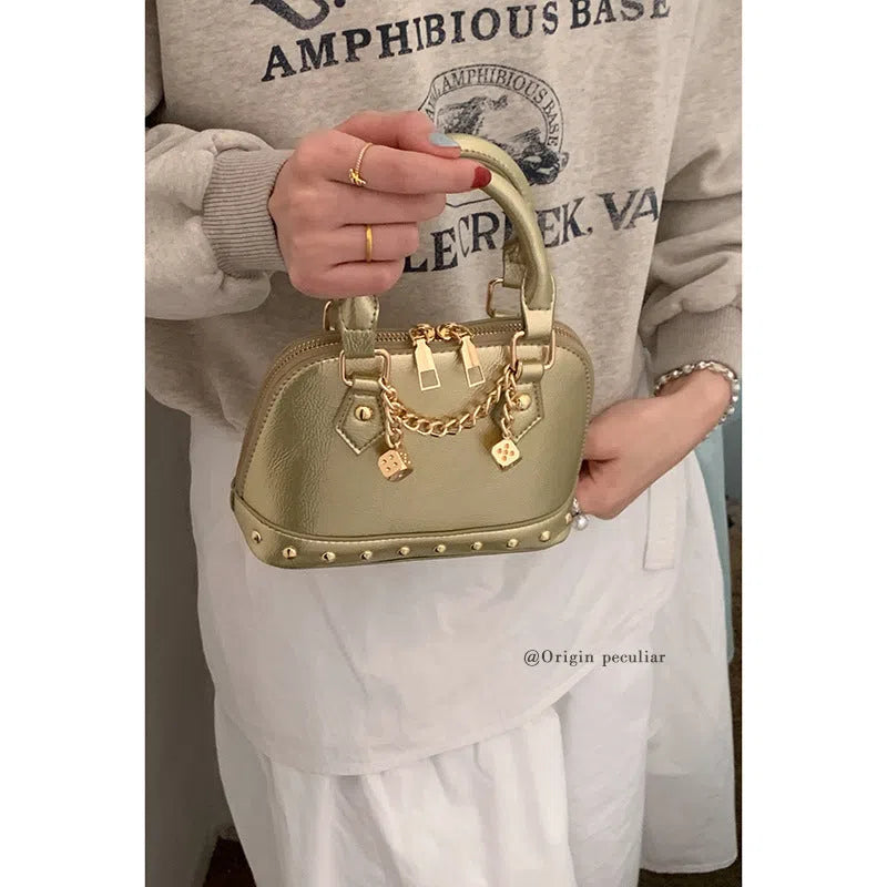Champagne-gold PU shell bag with stitched seams, shown in shoulder mode against a neutral background