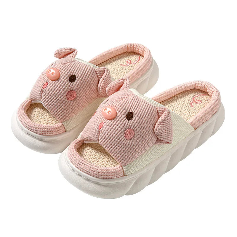 A pair of Piggy Cute linen couple slippers in open toe flip flop style on a plain background.