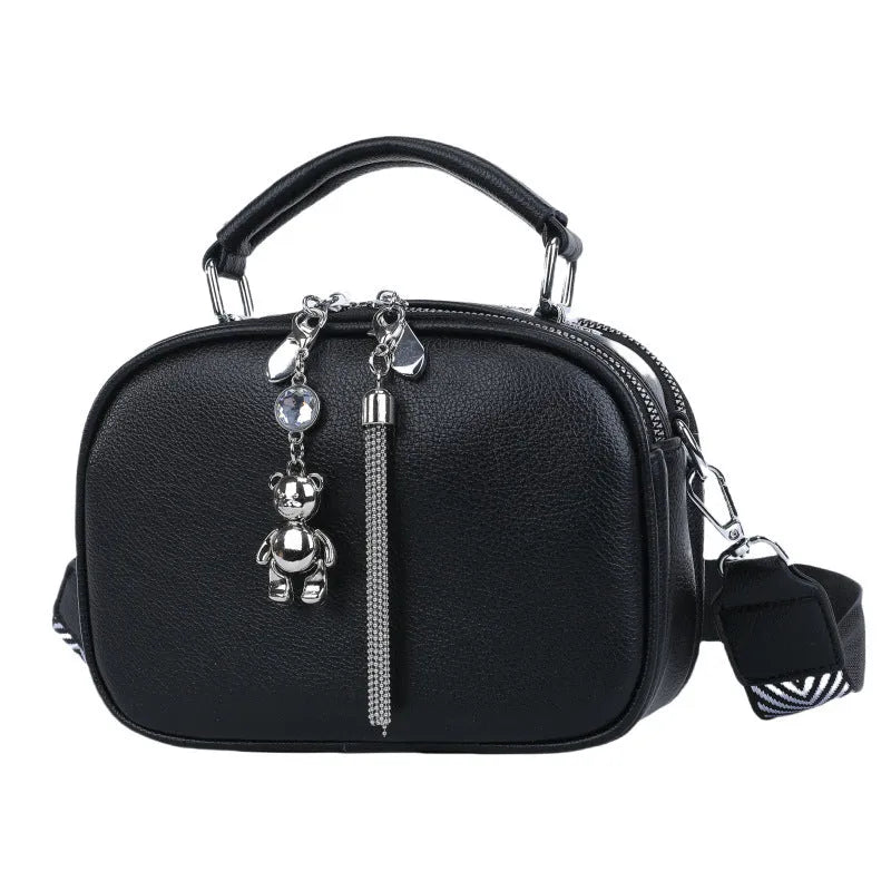 Women's small square bag with stitching detail showing oval shape and double shoulder straps