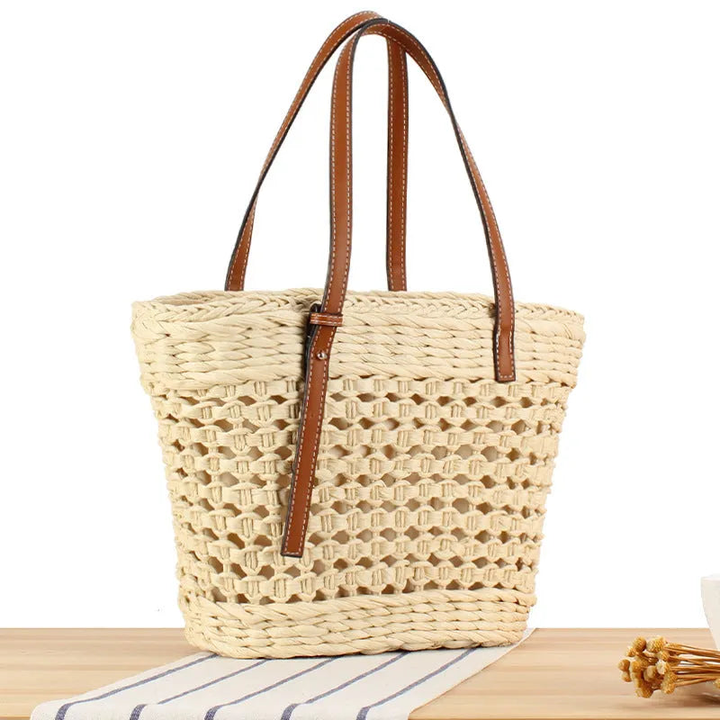 Horizontal square shoulder bag woven from paper-string with adjustable strap in beige colour