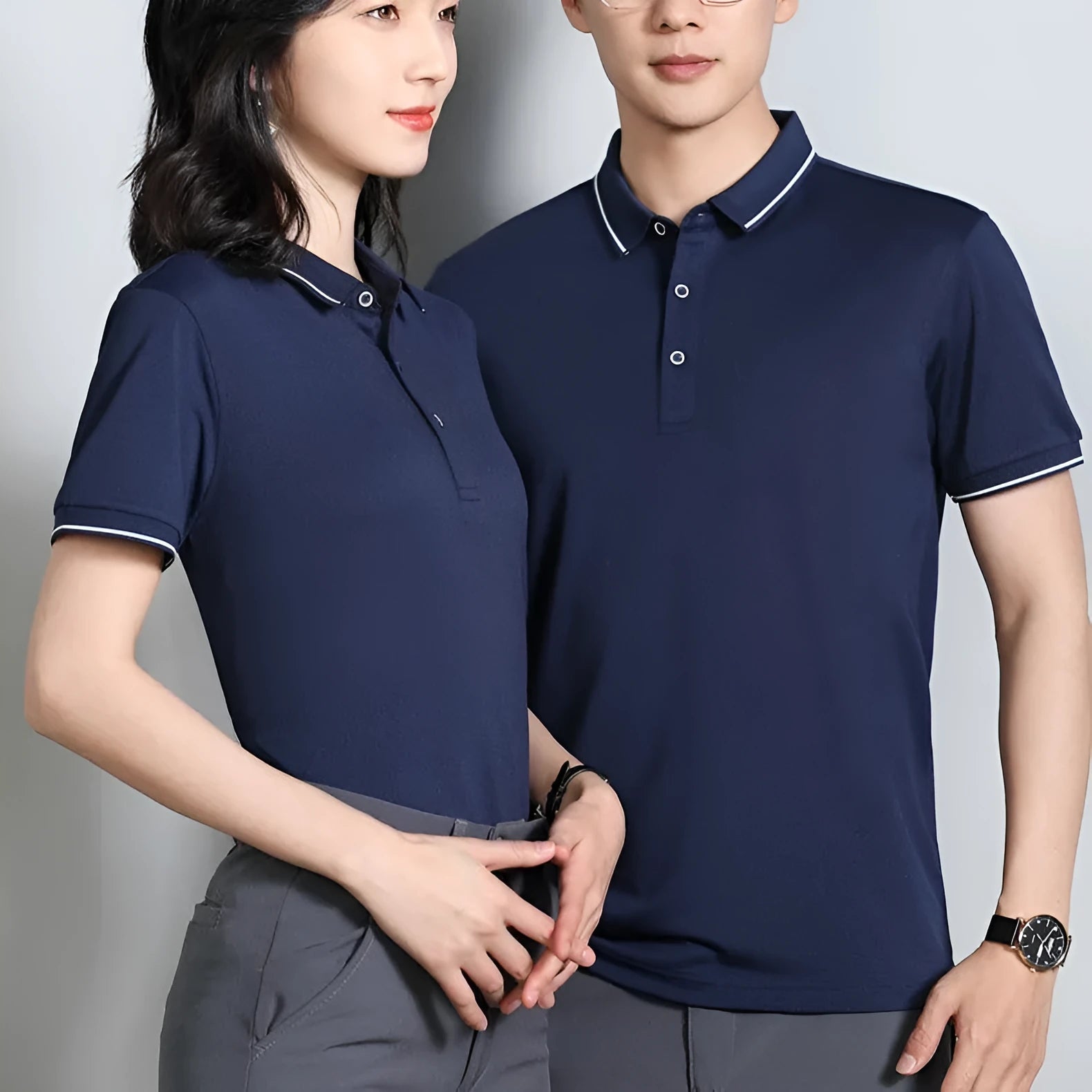 Beautician wearing a short-sleeved light blue polo shirt with asymmetric detail in a salon setting