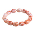 Natural cherry agate barrel bead bracelet with Ruyi symbols on a white background.