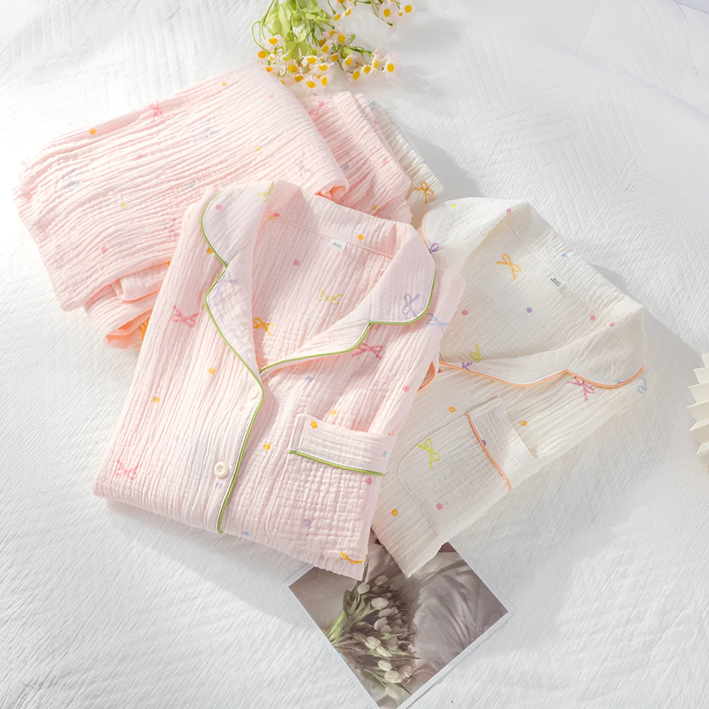 Women's cotton pajamas set in pink and beige colours showing long sleeves and trousers-length pants