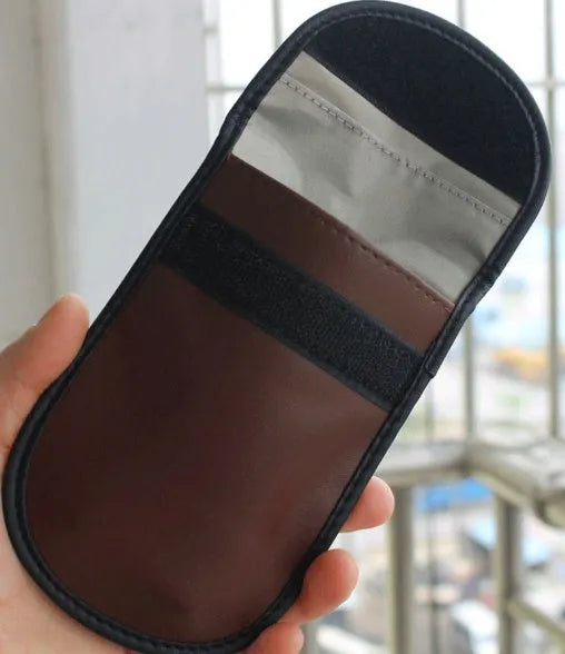 Black RFID signal blocker bag showing 13.5cm by 9.5cm dimensions on a flat surface.