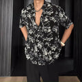 Loose fit short sleeve floral print shirt in white, shown on a hanger.
