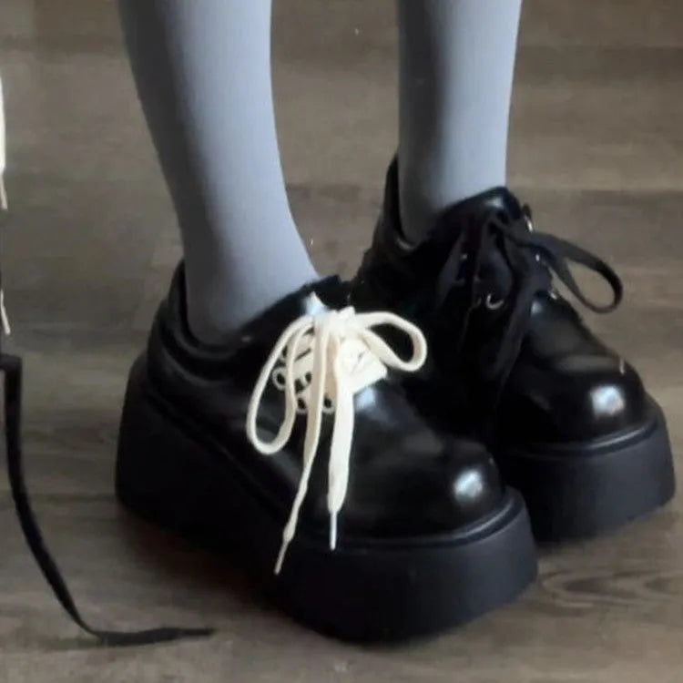Matte black women's lace-up high-heeled shoes with a thick rubber sole and English muffin heel.