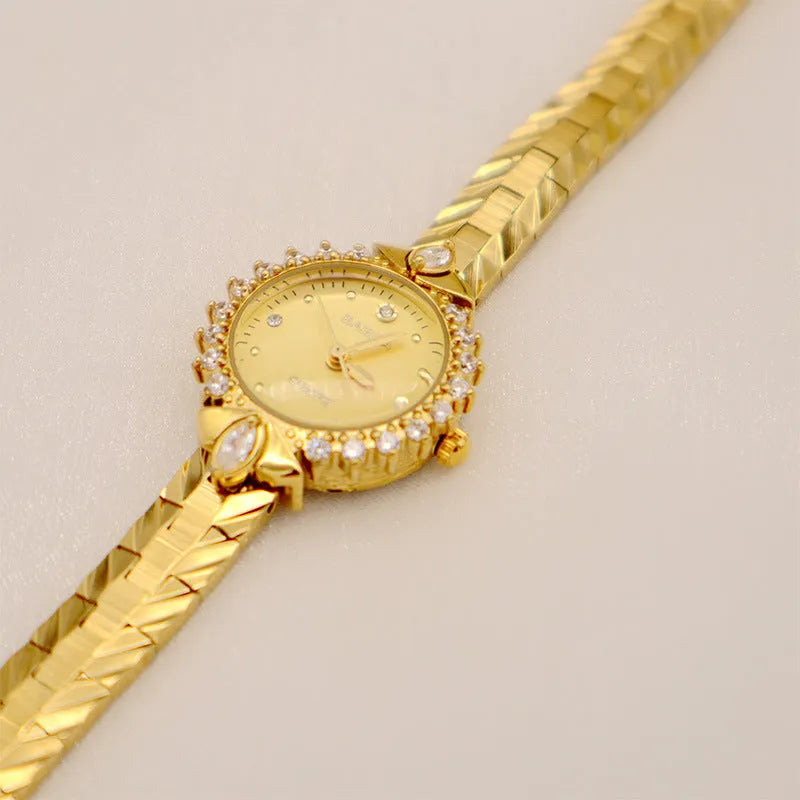 Women's vintage-style quartz watch with diamond-embossed gold bracelet