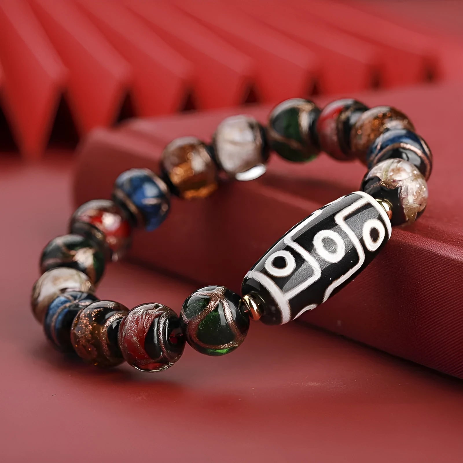 Close-up of a handmade Chinese-style bracelet with coloured glaze lucky beads on a snake theme.