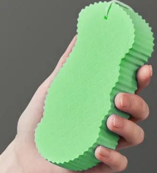 White 3D fish scale pattern bath sponge ball for gentle body exfoliation in the shower.