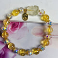 Handmade natural citrine crystal bracelet with detailed nine-tail fox design on a white background.