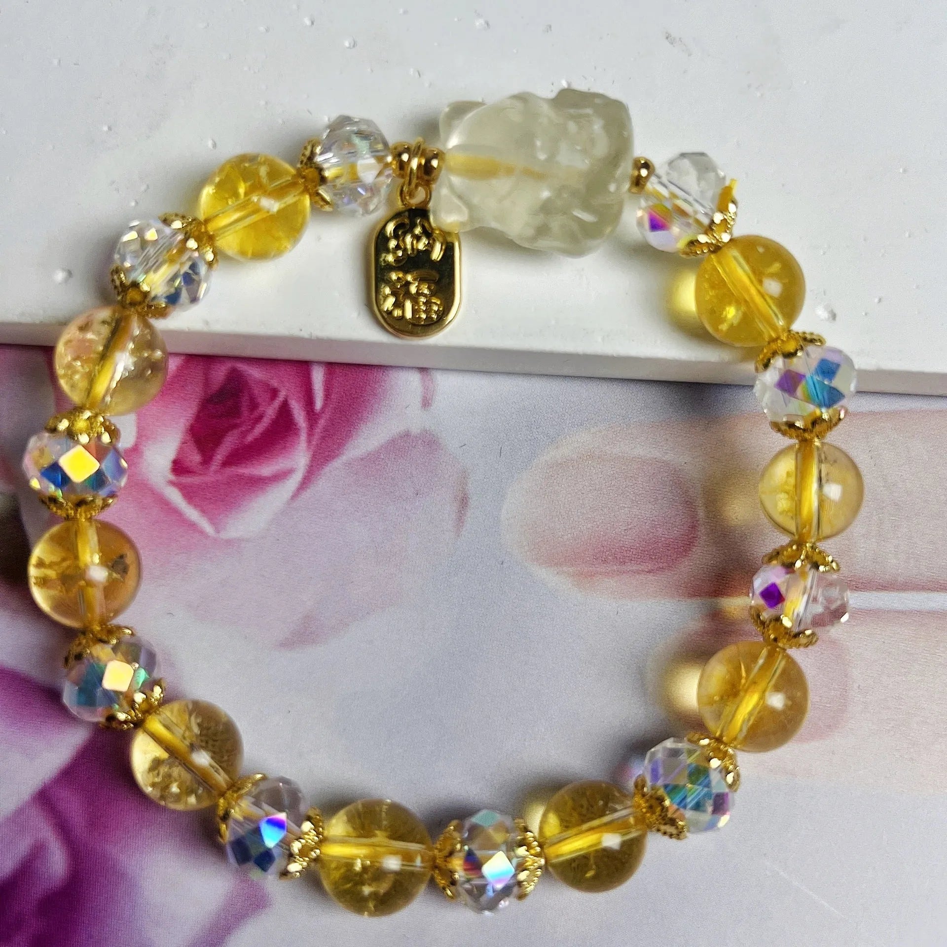 Handmade natural citrine crystal bracelet with detailed nine-tail fox design on a white background.