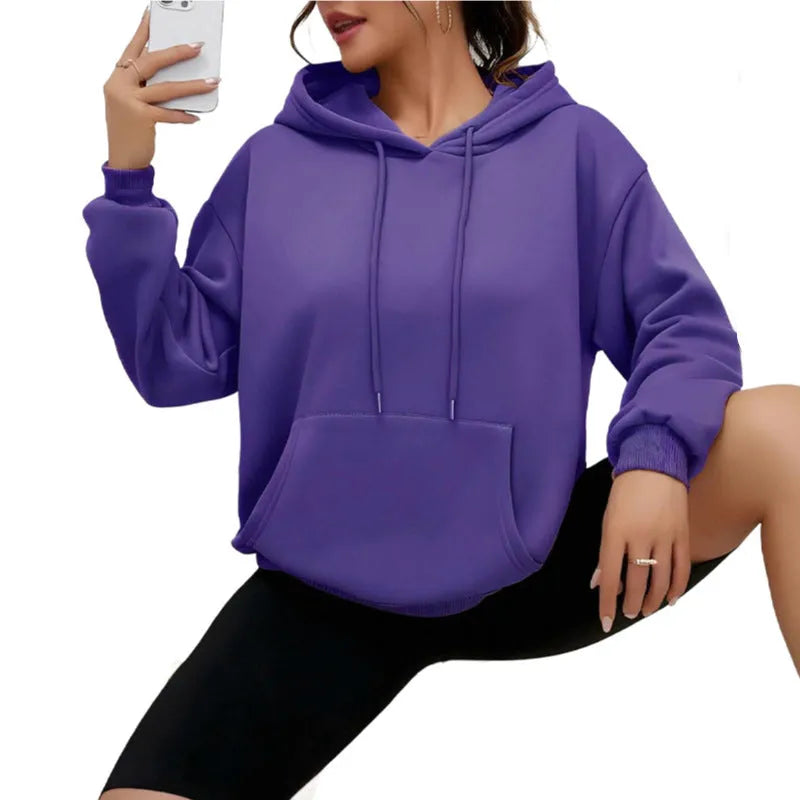 Women's loose grey drawstring pocket sweatshirt on a hanger showing front detail.