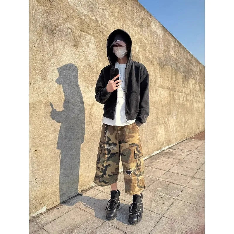Men's loose straight-leg jeans in camouflage colour with cropped length and distressed patch detailing