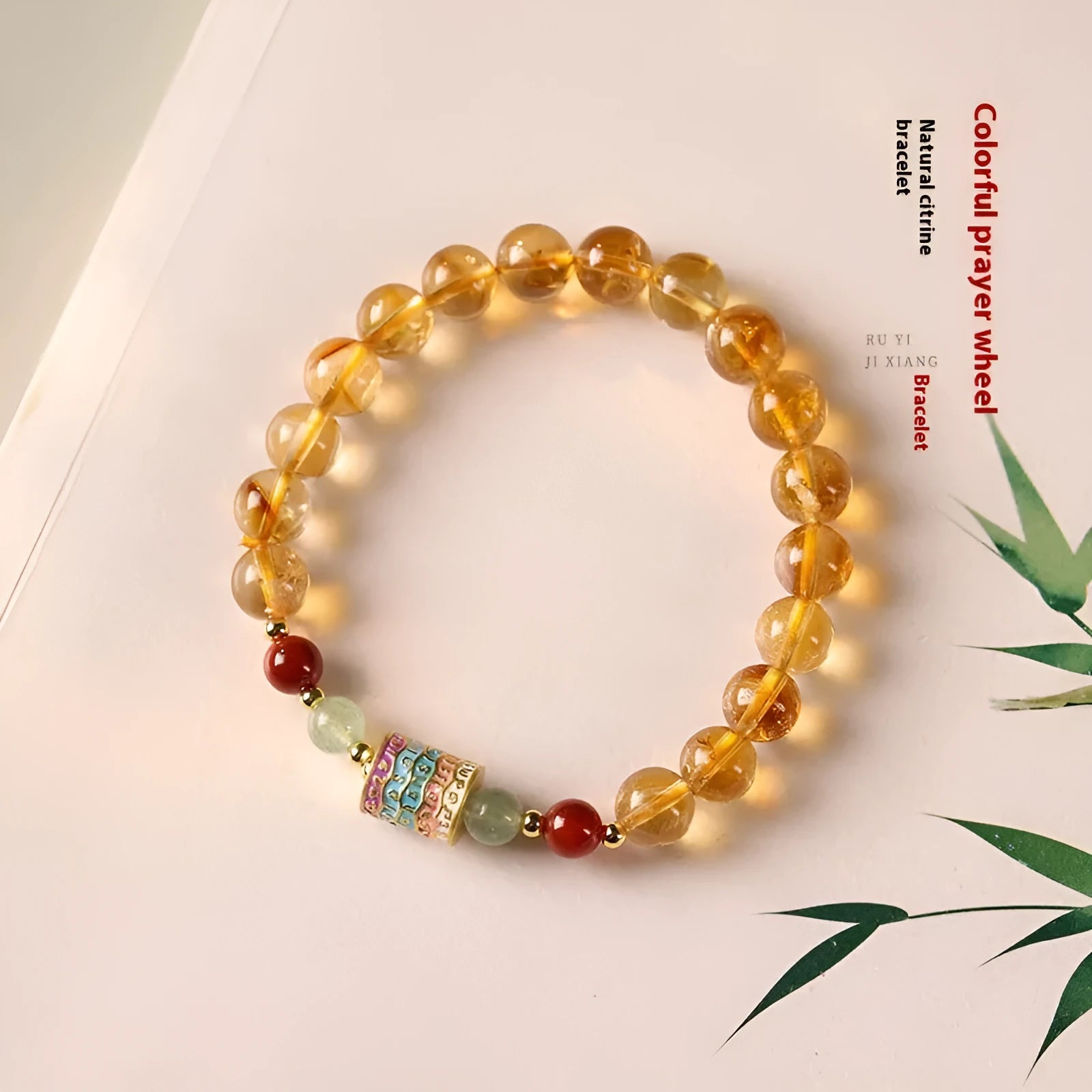 Yellow citrine prayer wheel bracelet with 8mm round beads on wrist