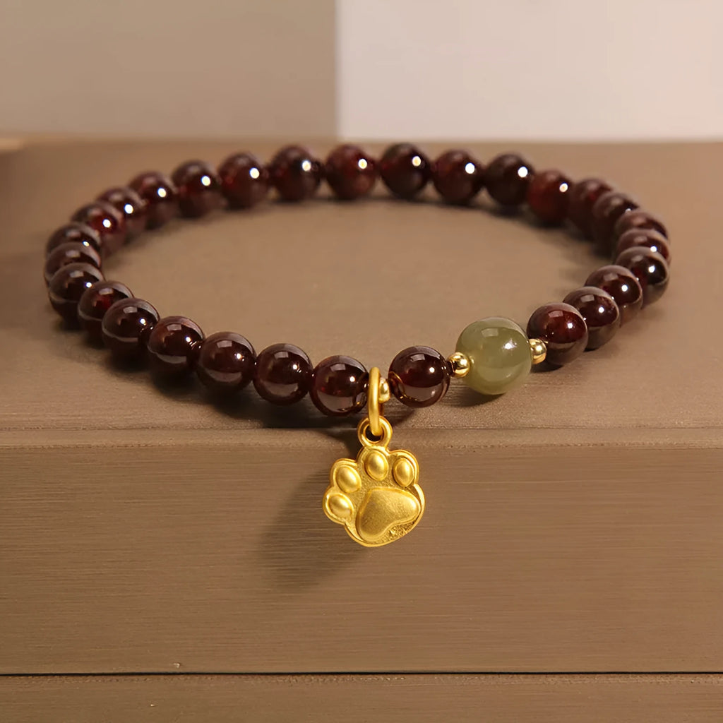 Women's Cat's Paw Garnet crystal bracelet on wrist, original design.