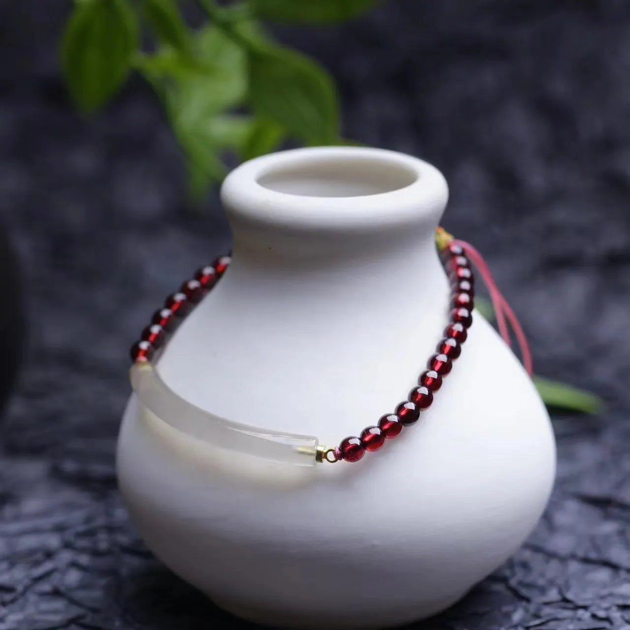 Red garnet and natural agate beaded bracelet with pull-adjustable closure on wrist