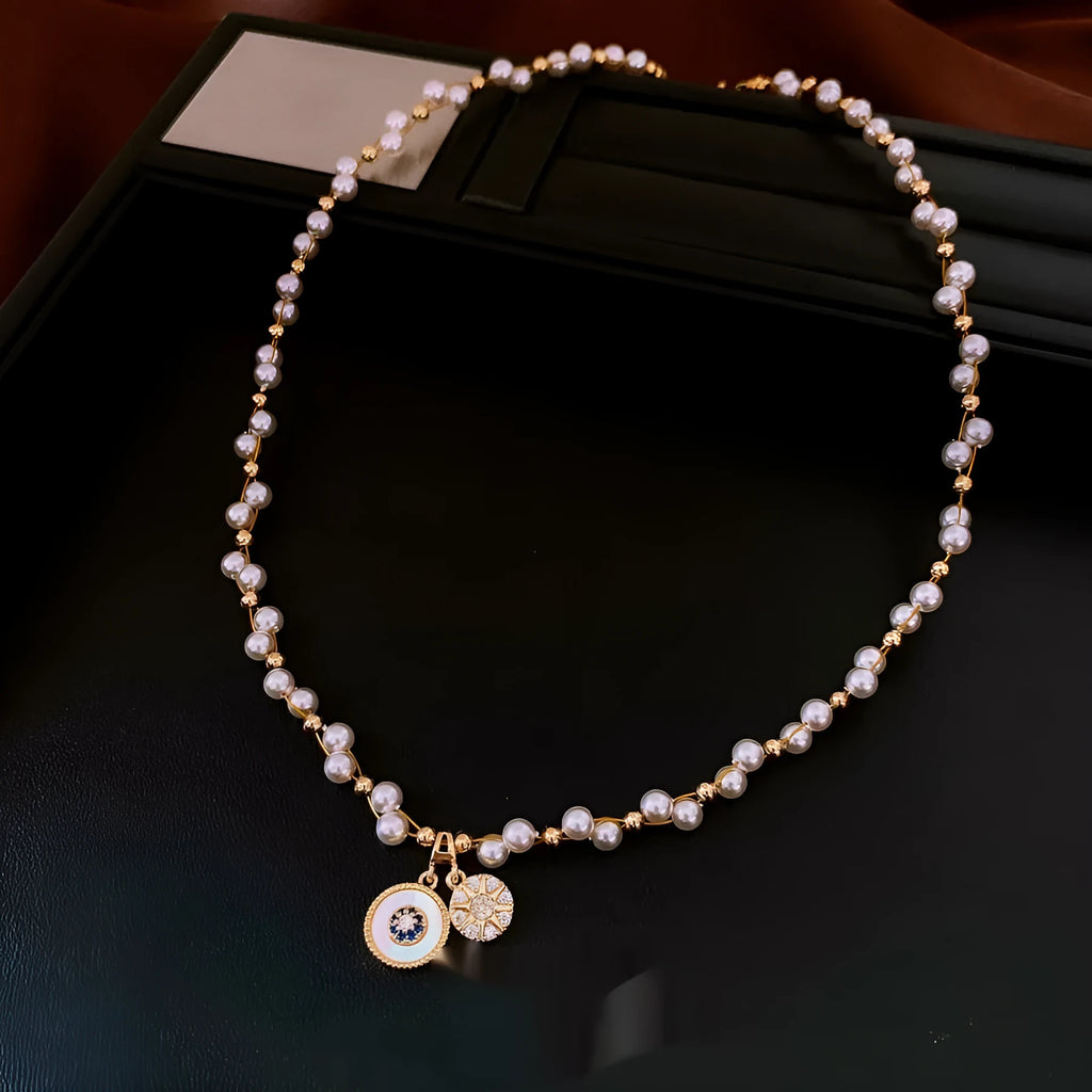 Gold-plated necklace with round pearl pendant and zircon accents on adjustable chain