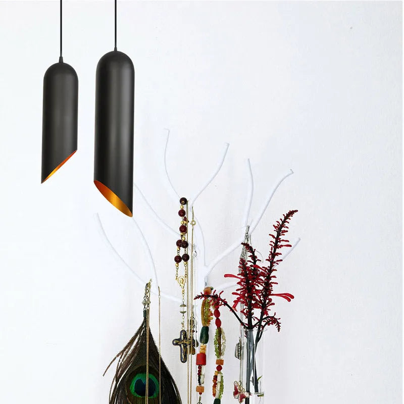 Matte black retro iron chandelier with multiple arms, shown against a neutral wall.