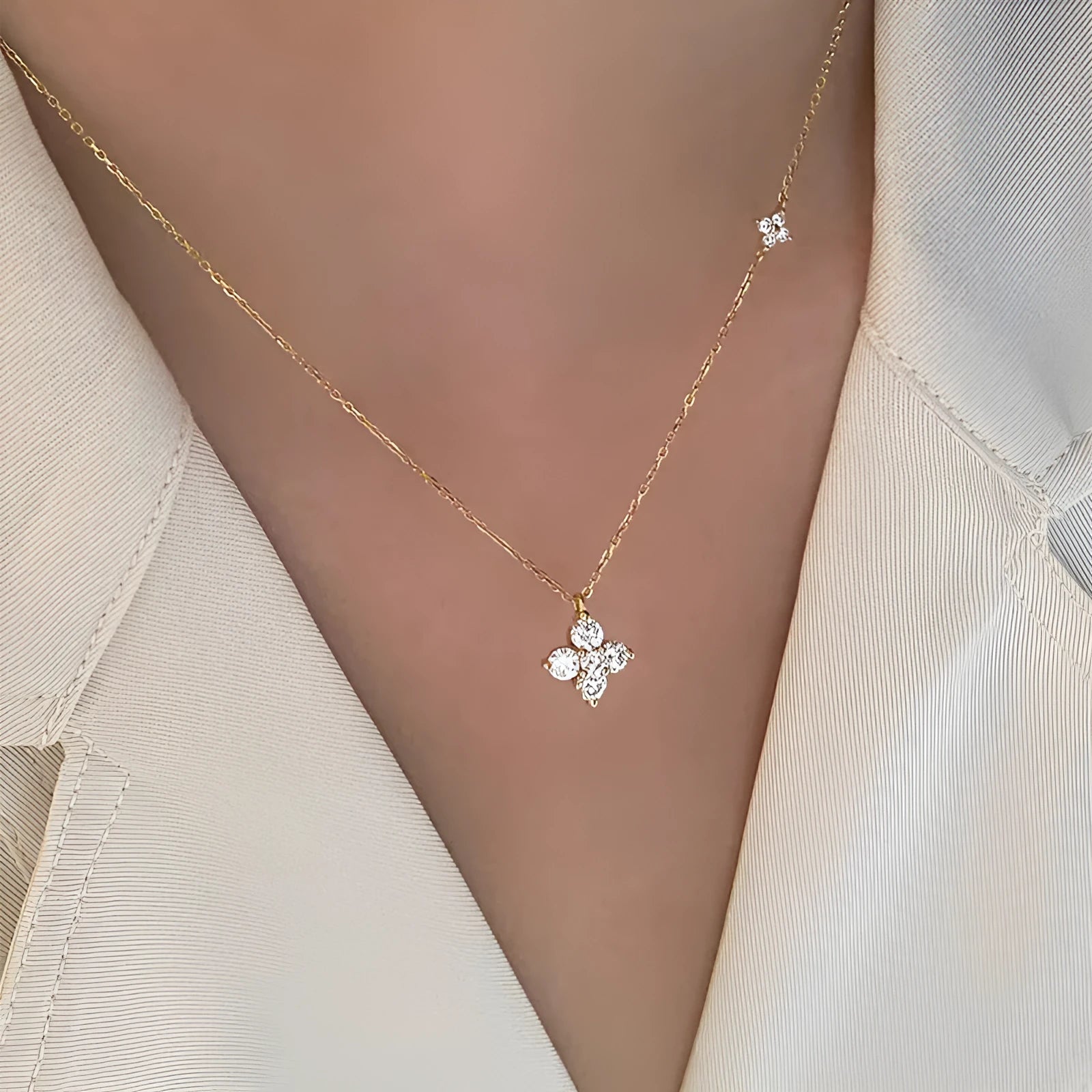 Silver clover clavicle chain necklace with O-ring chain and flower pendant on white background