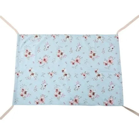 Portable crushed velour baby hammock attached to a white crib, shown in a pink colour.