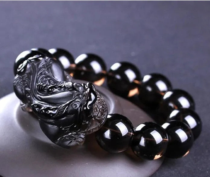 Kaiguang natural ice species black anthracite raspberry stone beaded bracelet on a plain background