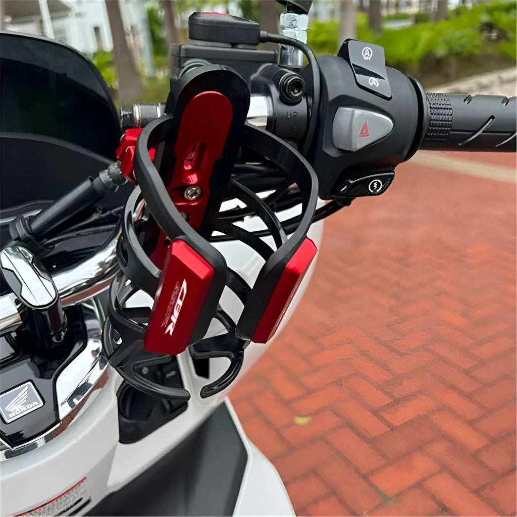Black modified water bottle cage mounted on a Honda X-ADV scooter.