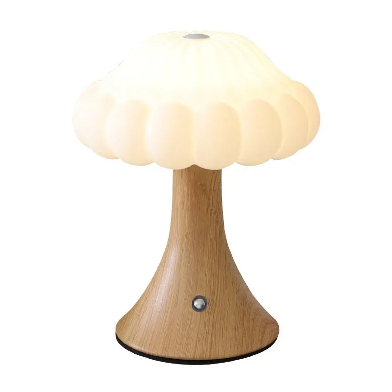 Small touch-controlled mushroom night lamp in wood grain colour on a table.