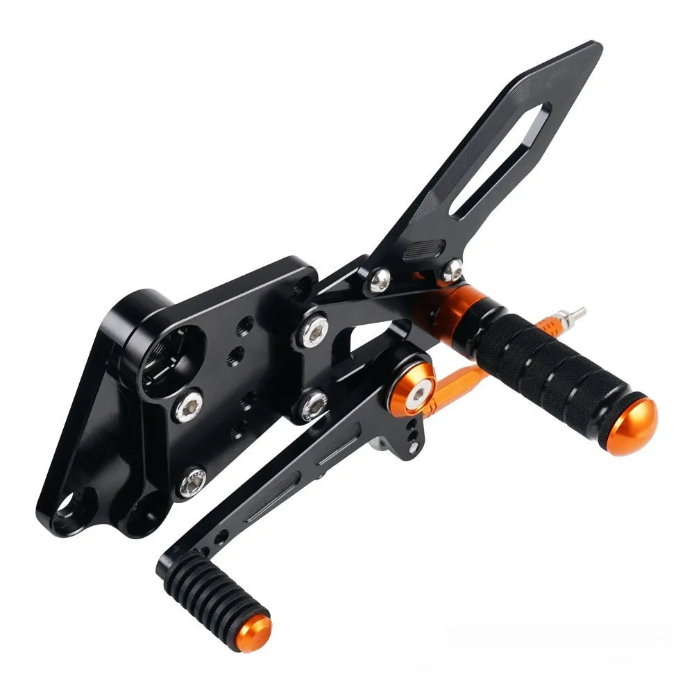 Black and orange KTM Duke motorcycle rear shift pedal support bracket assembly.